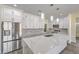 Modern kitchen with white cabinetry, an island with a marble countertop, and stainless steel appliances at 4801 Stoneham, Pahrump, NV 89061
