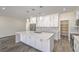 Spacious kitchen featuring white cabinetry, a central island with marble countertop, and stainless steel appliances at 4801 Stoneham, Pahrump, NV 89061