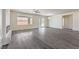 Bright living room with gray wood floors, modern fireplace, ceiling fan, and sliding glass door at 4801 Stoneham, Pahrump, NV 89061