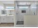 Luxurious walk-in shower with glass enclosure, tiled walls, and dual shower heads in primary bathroom at 4801 Stoneham, Pahrump, NV 89061