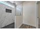 Modern shower with glass enclosure, tiled walls, and black tiled floor in the primary bathroom at 4801 Stoneham, Pahrump, NV 89061