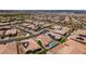 A high-angle shot capturing a neighborhood with lush backyard pools, solar panels and well-manicured landscaping at 489 Intonation St, Henderson, NV 89011