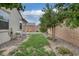 Fenced backyard featuring gravel and grass with desert landscaping and block wall for privacy at 489 Intonation St, Henderson, NV 89011