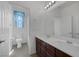 Bathroom featuring a double vanity with dark wood cabinets and blue window covering at 489 Intonation St, Henderson, NV 89011