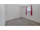 This bedroom has gray carpeting and a window with bright red curtains at 489 Intonation St, Henderson, NV 89011