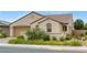 Single-Gathering home with a barrel tile roof, desert landscaping, and a two-car garage at 489 Intonation St, Henderson, NV 89011