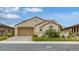 Charming single-story home with a well-manicured lawn, inviting curb appeal, and a two-car garage at 489 Intonation St, Henderson, NV 89011