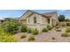Home with low-maintenance desert landscaping, charming exterior accents, and a tile roof at 489 Intonation St, Henderson, NV 89011