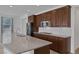 Bright kitchen with granite counters, stainless appliances, gas cooktop, tile backsplash, and large island at 489 Intonation St, Henderson, NV 89011