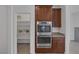 Modern kitchen featuring stainless steel ovens, custom cabinets, and a convenient walk-in pantry at 489 Intonation St, Henderson, NV 89011