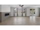 Open-concept living area featuring tile floors, a modern fireplace, and plenty of natural light at 489 Intonation St, Henderson, NV 89011