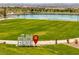 Inviting park with a welcoming sign, lush lawn, and a serene lake, perfect for outdoor enjoyment at 489 Intonation St, Henderson, NV 89011