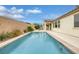 Inviting backyard with a private pool, patio, seating area, and lush landscaping at 489 Intonation St, Henderson, NV 89011