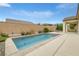 Relaxing backyard with a sparkling swimming pool, patio area, and a blue patio umbrella at 489 Intonation St, Henderson, NV 89011