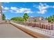 View from the balcony overlooking desert landscaping and palm trees on a sunny day at 5015 Thunder River Cir, Las Vegas, NV 89148