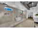 Modern bathroom with a standalone tub, walk-in shower, and sleek tile at 5015 Thunder River Cir, Las Vegas, NV 89148