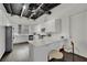 Modern white kitchen with sleek cabinetry, stainless steel appliances, breakfast bar seating, and an open layout at 5015 Thunder River Cir, Las Vegas, NV 89148