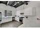 Bright and modern kitchen featuring white cabinets, stainless steel appliances, and sleek countertops with dark floors at 5015 Thunder River Cir, Las Vegas, NV 89148