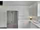 A close up of the bright kitchen and refrigerator showing white cabinets at 5015 Thunder River Cir, Las Vegas, NV 89148