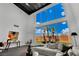 Bright living room with high ceilings, modern furniture, and expansive windows overlooking the backyard at 5015 Thunder River Cir, Las Vegas, NV 89148