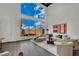 Bright living room with high ceilings, modern furniture, and expansive windows overlooking the backyard at 5015 Thunder River Cir, Las Vegas, NV 89148