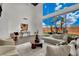Bright living room with high ceilings, modern furniture, and expansive windows overlooking a green yard at 5015 Thunder River Cir, Las Vegas, NV 89148