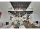 Open-concept living space with industrial-style ceiling, modern decor, and hardwood floors at 5015 Thunder River Cir, Las Vegas, NV 89148