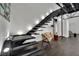 Modern staircase with industrial design, ambient lighting, and sleek metal accents at 5015 Thunder River Cir, Las Vegas, NV 89148