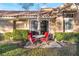 Cozy back patio with lush landscaping and outdoor seating for relaxing or entertaining guests at 5058 Crooked Stick Way, Las Vegas, NV 89113