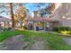Inviting backyard with a private patio, outdoor furniture, lush lawn, mature trees, and tasteful landscaping at 5058 Crooked Stick Way, Las Vegas, NV 89113
