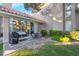 Inviting backyard with a private patio, outdoor furniture, lush lawn, mature trees, and tasteful landscaping at 5058 Crooked Stick Way, Las Vegas, NV 89113