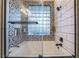 The bathtub has decorative black and white tile and glass block window at 5058 Crooked Stick Way, Las Vegas, NV 89113