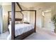 Bright bedroom with a four-poster bed, closet, and access to a hallway and closet at 5058 Crooked Stick Way, Las Vegas, NV 89113