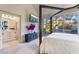 Bedroom with a four-poster bed, TV, and access to the patio with a view of the water at 5058 Crooked Stick Way, Las Vegas, NV 89113
