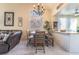 Bright dining area featuring modern chandelier and breakfast bar access at 5058 Crooked Stick Way, Las Vegas, NV 89113
