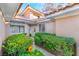 Inviting home entryway with beautiful front door, green shrubs, and walkway at 5058 Crooked Stick Way, Las Vegas, NV 89113