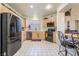 Well-lit kitchen features stainless steel appliances, wood cabinets, and tile flooring at 5058 Crooked Stick Way, Las Vegas, NV 89113