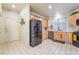 Well-lit kitchen features stainless steel appliances, wood cabinets, and tile flooring at 5058 Crooked Stick Way, Las Vegas, NV 89113