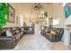 Spacious living room with vaulted ceilings, neutral carpet and comfortable brown leather furniture at 5058 Crooked Stick Way, Las Vegas, NV 89113