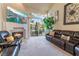 Comfortable living room with fireplace, large-screen television and slider doors to patio at 5058 Crooked Stick Way, Las Vegas, NV 89113