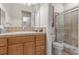 Bathroom with a shower featuring glass doors, a vanity with drawers, and tiled countertops at 51 Avenida Sorrento, Henderson, NV 89011