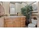 Cozy bathroom featuring a decorative mirror, plant, toilet, and neutral color palette at 51 Avenida Sorrento, Henderson, NV 89011