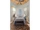Bedroom with cathedral ceiling, a bed, two side tables, curtains, blinds and an area rug at 51 Avenida Sorrento, Henderson, NV 89011