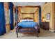 Comfortable bedroom featuring a canopy bed, warm wall color and a seating bench in front of the bed at 51 Avenida Sorrento, Henderson, NV 89011