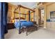 Comfortable bedroom featuring a canopy bed, warm wall color and a seating bench in front of the bed at 51 Avenida Sorrento, Henderson, NV 89011