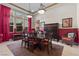 Inviting dining area features a table with seating, red curtains, and views of the landscaped outdoors at 51 Avenida Sorrento, Henderson, NV 89011