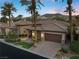 Attractive home featuring a well-manicured front yard, a stone facade, and a two-car garage at 51 Avenida Sorrento, Henderson, NV 89011