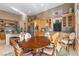 Open kitchen and breakfast nook with wooden cabinetry, stainless appliances, and table with four chairs at 51 Avenida Sorrento, Henderson, NV 89011