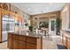 Bright kitchen with granite countertops, stainless appliances, and a breakfast nook with a view of the backyard at 51 Avenida Sorrento, Henderson, NV 89011