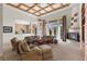 Spacious living room features a fireplace, coffered ceilings, and large windows for lots of natural light at 51 Avenida Sorrento, Henderson, NV 89011